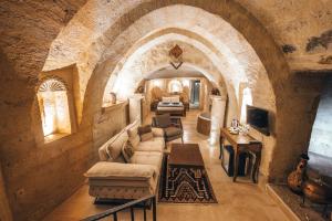 a living room with a couch and a table at Lagania In Cave in Urgup