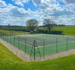 a tennis court with a net on a field at Arkle in Kelling