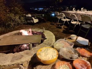 a grill with a bunch of food on a table at Casa laberinto, Entre cerros, cómoda cama de 2x2 in Salta