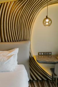 a hotel room with a bed and a table at Vila Foz Hotel & SPA - member of Design Hotels in Porto