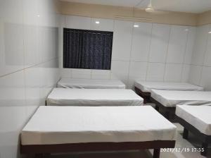 a room with four mattresses in it with a window at Quilon Residency in Alleppey +15 photos
