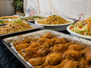 a buffet with many different dishes of food on a table at Darling Harbour Hostel - Near ICC in Sydney