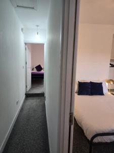 a room with a bed and a hallway with a bedroom at The Grand four bed getaway- Sleeps 9-free on street parking in Birmingham +5 photos