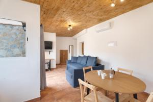 a living room with a table and a blue couch at Vivienda vacacional La Era I in Vallehermoso
