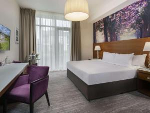a hotel room with a bed and a desk at Moyvalley Hotel & Golf Resort in Enfield +45 photos
