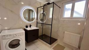 a bathroom with a washing machine and a mirror at Europole 1 Gare de Grenoble & Centre Ville in Grenoble +11 photos