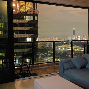 a living room with a view of a city at Astoria Ampang x Near KLCC TRX BigRoom 12pax in Kuala Lumpur