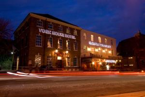 a building on the side of a street at night at York House Hotel in Wakefield