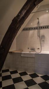 a bathroom with a shower and a bath tub at Hotel De Limbourg in Sittard +36 photos
