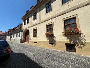 a building with flower boxes on the side of a street at Lucasi apartament in Sibiu