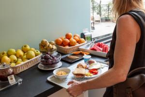 a woman standing in front of a counter with food at Plus Florence in Florence