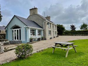 a house with a picnic table in front of it at Country Farm House in Bruckless +14 photos
