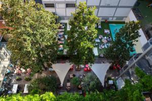 an overhead view of a courtyard with trees in a building at Plus Florence in Florence