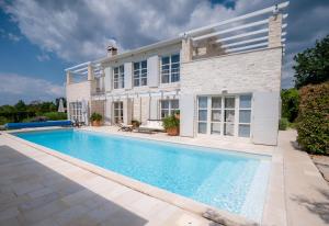an exterior view of a house with a swimming pool at Villa Moonlight 1 near Poreč for 9 person - pet friendly with large garden, playground & 50 m2 pool in Višnjan +23 photos