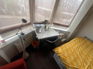 a bedroom with a bed and a desk and a window at In the heart of central London in London