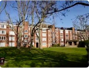 a large brick building with trees in front of it at In the heart of central London in London