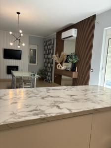 a kitchen and dining room with a marble counter top at Villa Castle View in Shkodër