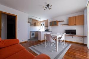 a kitchen and a living room with a table and chairs at Relax en Caldebarcos in Caldebarcos