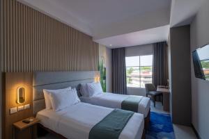Letto o letti in una camera di Oakwood Merdeka Bandung