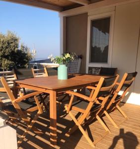 a wooden table and chairs on a deck at Mobilna kućica MAAR in Šimuni