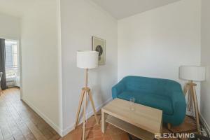 a living room with a blue chair and a table at Flexliving - room - Lemoine in Paris