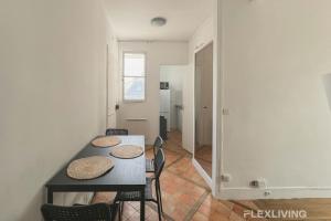 a dining room with a table and chairs and a hallway at Flexliving - room - Lemoine in Paris +6 photos