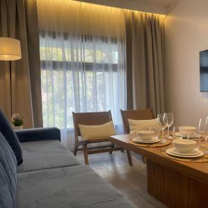 a living room with a table and chairs and a couch at Park Apartments in Mendoza