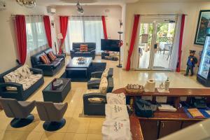 a large living room with couches and a table at Guest Wharf - Centre Ville in Pointe-Noire