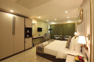 a hotel room with a bed and a bathroom at EMILYS By JDANIELS in Trivandrum