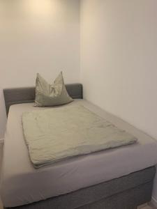 a bed with two pillows on top of it at Apartments Mitte Messe und Zentrum Heistersteg in Nürnberg