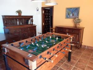 a room with a foosball table in the middle at Casa Rural Puentes Mediana in Olmedo