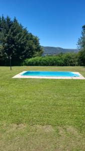 a swimming pool in the middle of a grass field at Casa en Potrero de Garay in Potrero de Garay