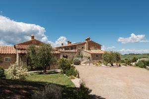 an estate with a large stone house with a driveway at Dimora Santa Margherita - Relais di Charme in Cinigiano