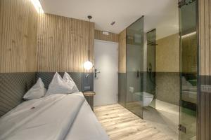a bedroom with a bed and a glass shower at B&B Boutique Hotel Burgund in Parcines +51 photos