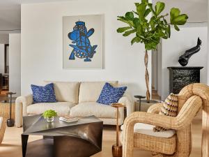 a living room with a couch and a table at The Roc Club, A Grecotel Hotel to Live in Athens