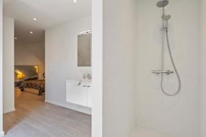 a white bathroom with a shower and a sink at Residentie Nevejan in Kortrijk +29 photos
