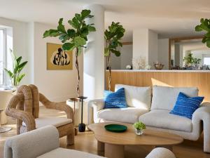 a living room with a couch and chairs and a table at The Roc Club, A Grecotel Hotel to Live in Athens