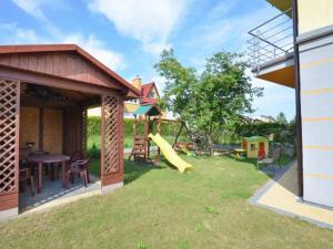 a backyard with a playground with a slide at Pokoje Gosia in Puck
