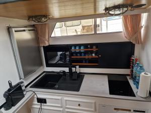 a kitchen in an rv with a sink at Fantasie Boot EINHORN in Cologne