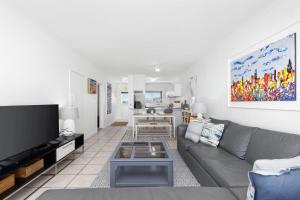 a living room with a couch and a tv at Odeon Towers 1102 in Strand
