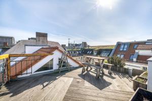a wooden deck with a bench on top of a building at Top floor Penthouse with Garden in Berlin