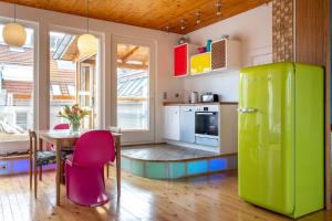 a kitchen with a table and a green refrigerator at Top floor Penthouse with Garden in Berlin +11 photos