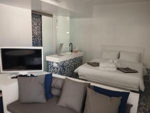 a living room with a couch and a television at Ergina Boutique Experience in Sisi +31 photos
