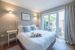 a bedroom with a bed with a tray of fruit on it at Captain's Quarters, a ground floor apartment in Aldeburgh in Aldeburgh