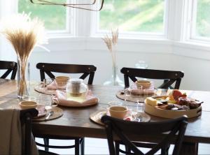 a wooden table with plates of food on it at Villa Solgården in Hanko