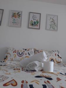 a bed with a blanket and pillows on it at LM Trav accommodation and reservation services in Tagaytay +3 photos