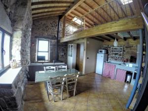 a kitchen and dining room with a table and chairs at Casa Quintas dos Mouros in Montederramo +54 photos