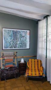 a room with a bed and a painting on the wall at Hostel Barreal in Barreal