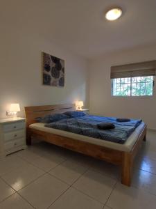 a bedroom with a bed and a nightstand and a window at 16 Sunset view in Adeje