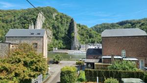 a view of a town with a river and mountains at L Orchidée in Dinant